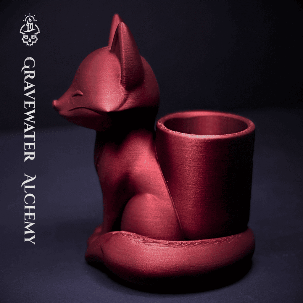 Bronze fox pen holder with closed eyes in a seated pose by Gravewater Alchemy