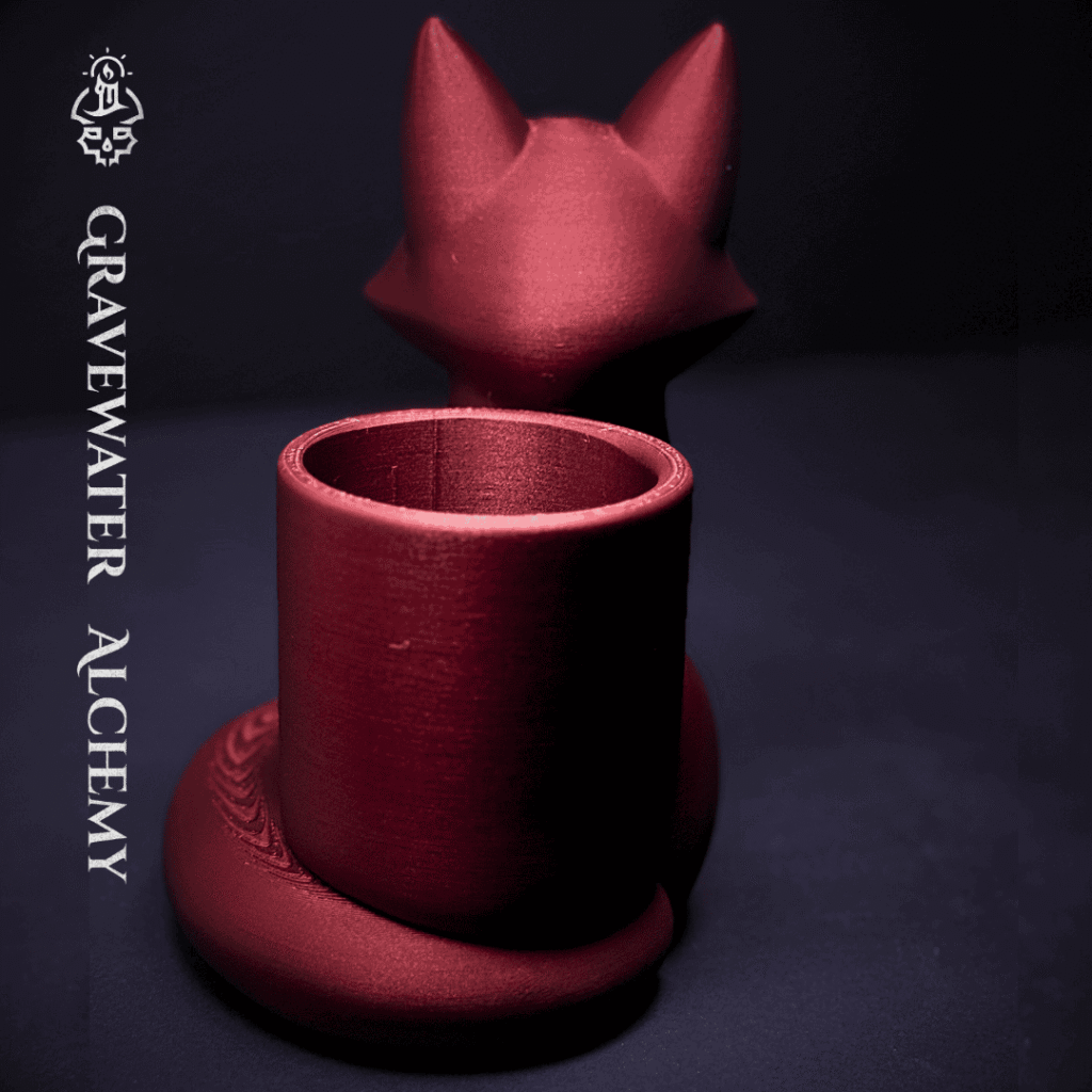 Bronze fox pen holder with closed eyes in a seated pose by Gravewater Alchemy