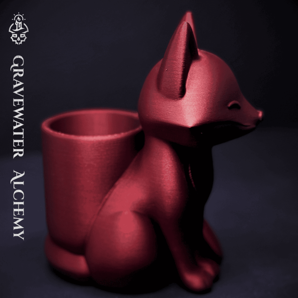 Bronze fox pen holder with closed eyes in a seated pose by Gravewater Alchemy