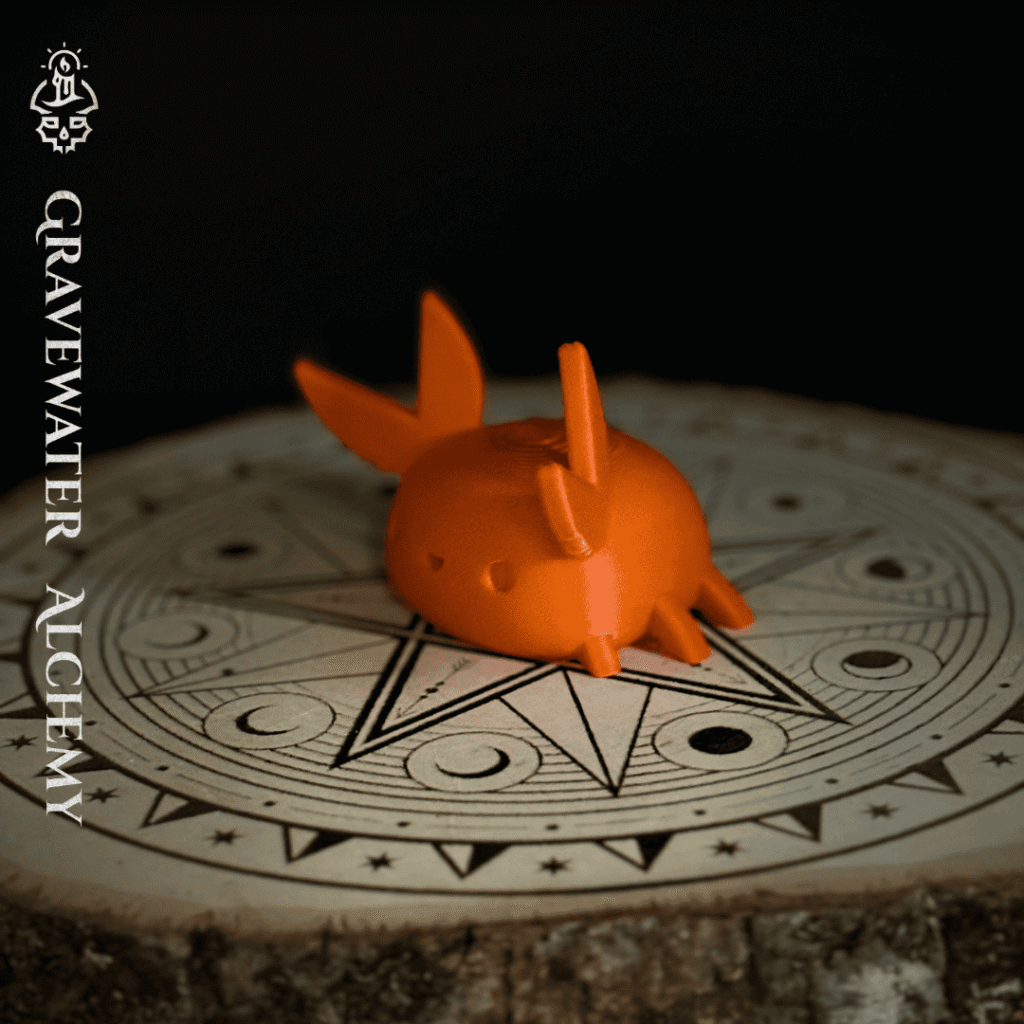 Orange crab figurine resting on an engraved alchemical sigil altar base by Gravewater Alchemy